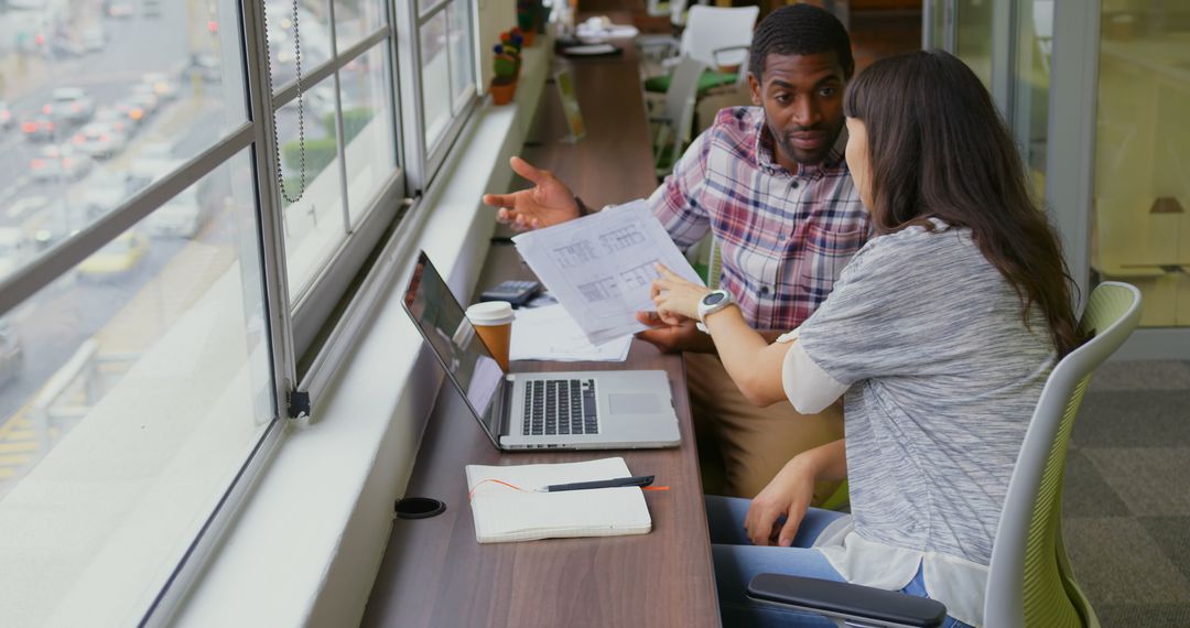 Collaborative Discussion over Office Desk with Laptop