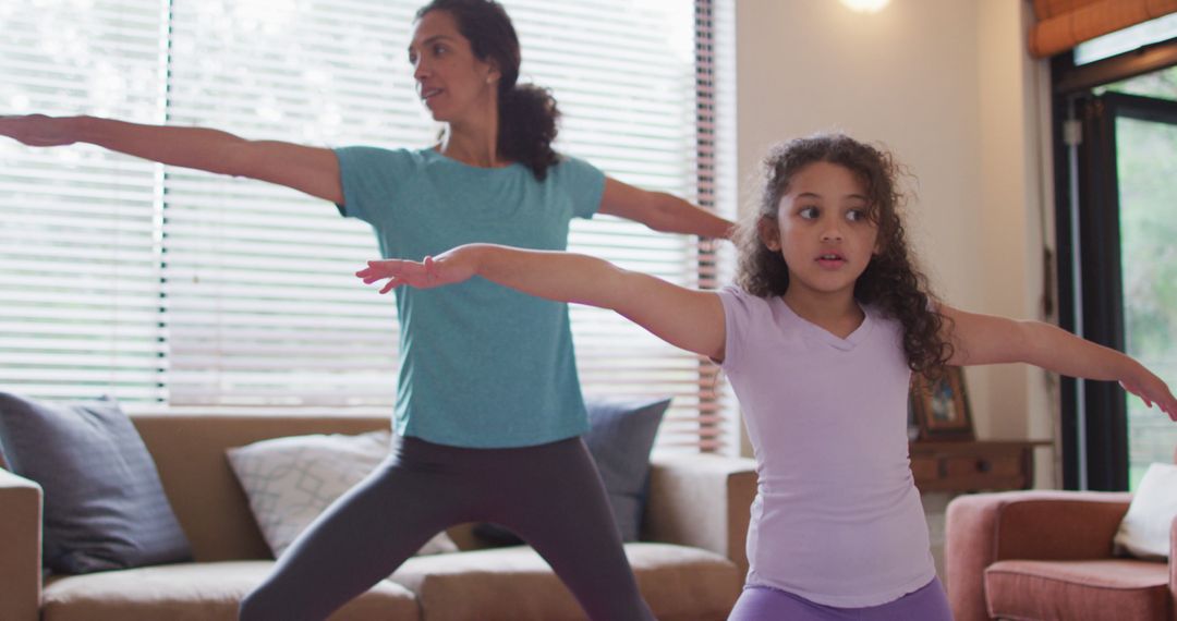 Biracial Mother and Daughter Practicing Yoga Together in Living Room - Free Images, Stock Photos and Pictures on Pikwizard.com