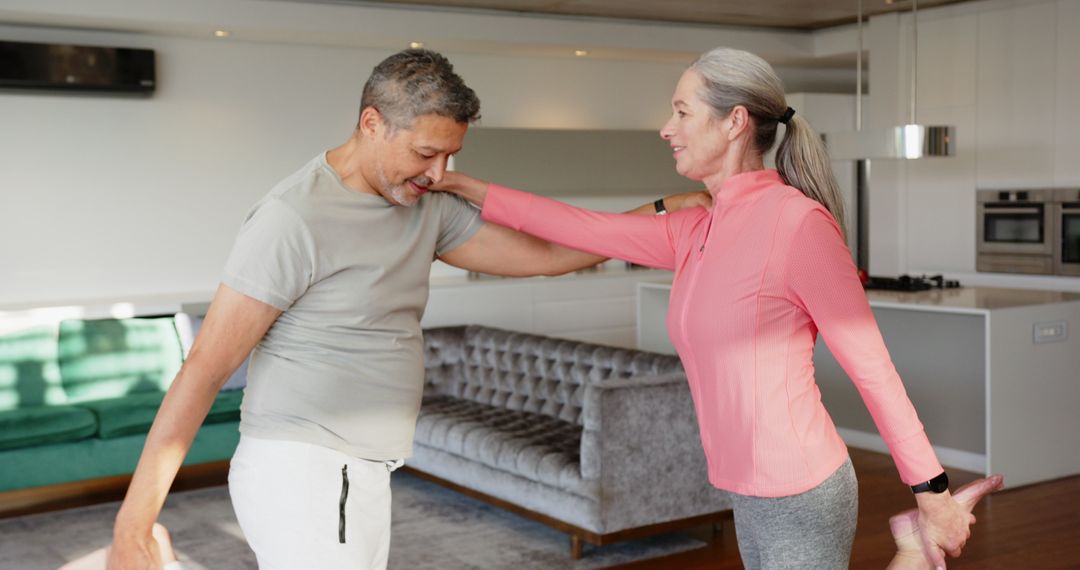 Senior Couple Balancing in Partner Stretch at Home