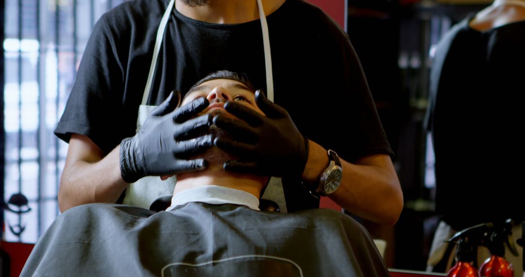 Barber Providing Detailed Shaving Service to Client