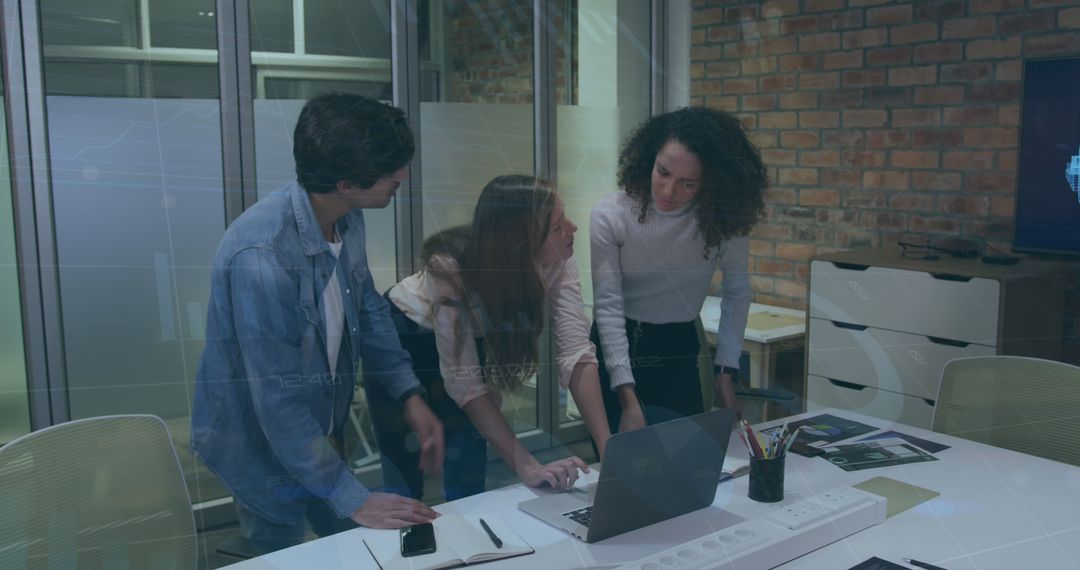 Diverse Team Collaborating on Laptops in Modern Office
