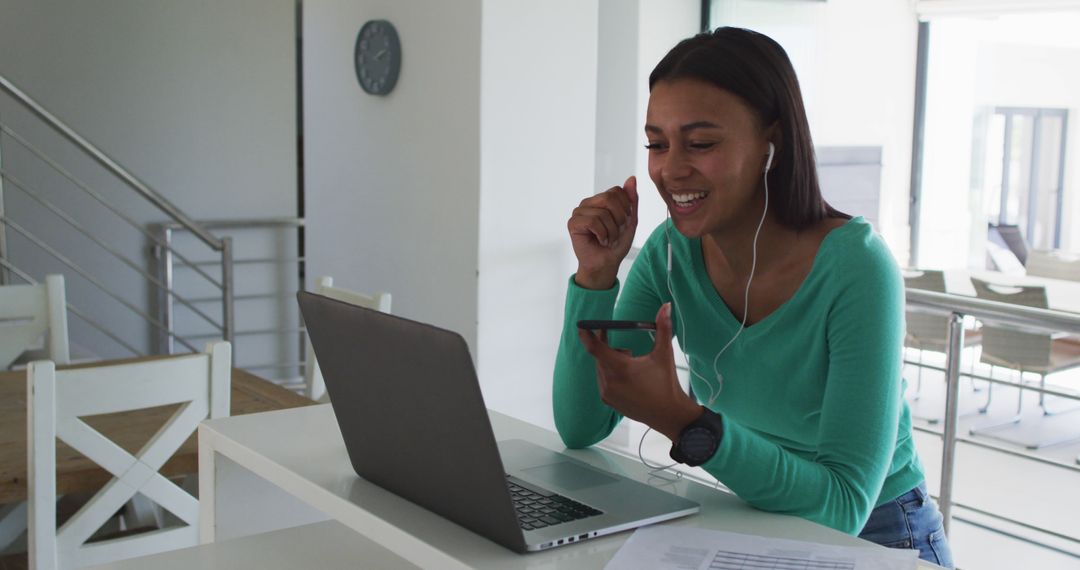 Young Woman Using Smartphone and Laptop at Home Office - Free Images, Stock Photos and Pictures on Pikwizard.com