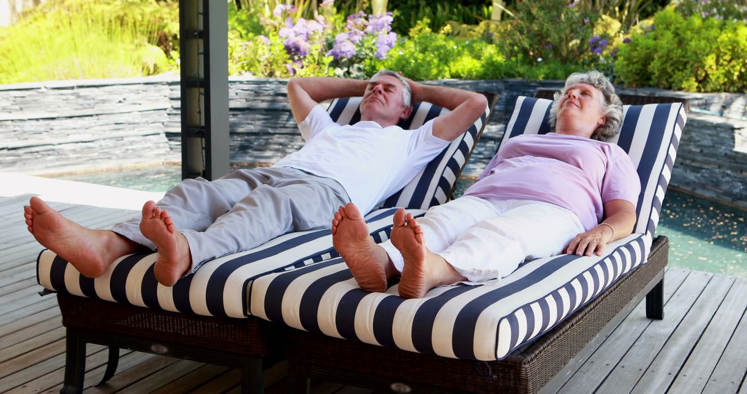 Senior Couple Relaxing on Poolside Lounge Chairs Outdoors - Free Images, Stock Photos and Pictures on Pikwizard.com