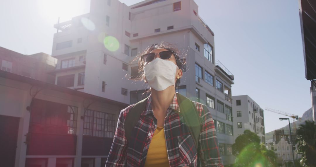 Young Woman Wearing Face Mask in the City Under Bright Sunlight - Free Images, Stock Photos and Pictures on Pikwizard.com