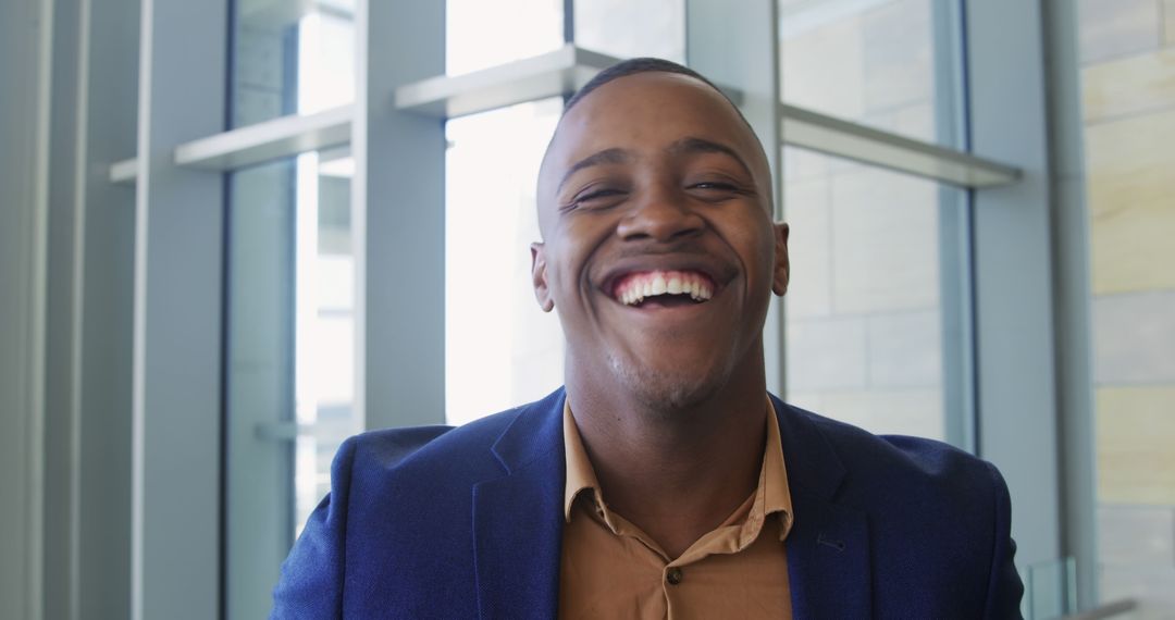 Smiling African American Man in Blue Suit Indoors - Free Images, Stock Photos and Pictures on Pikwizard.com