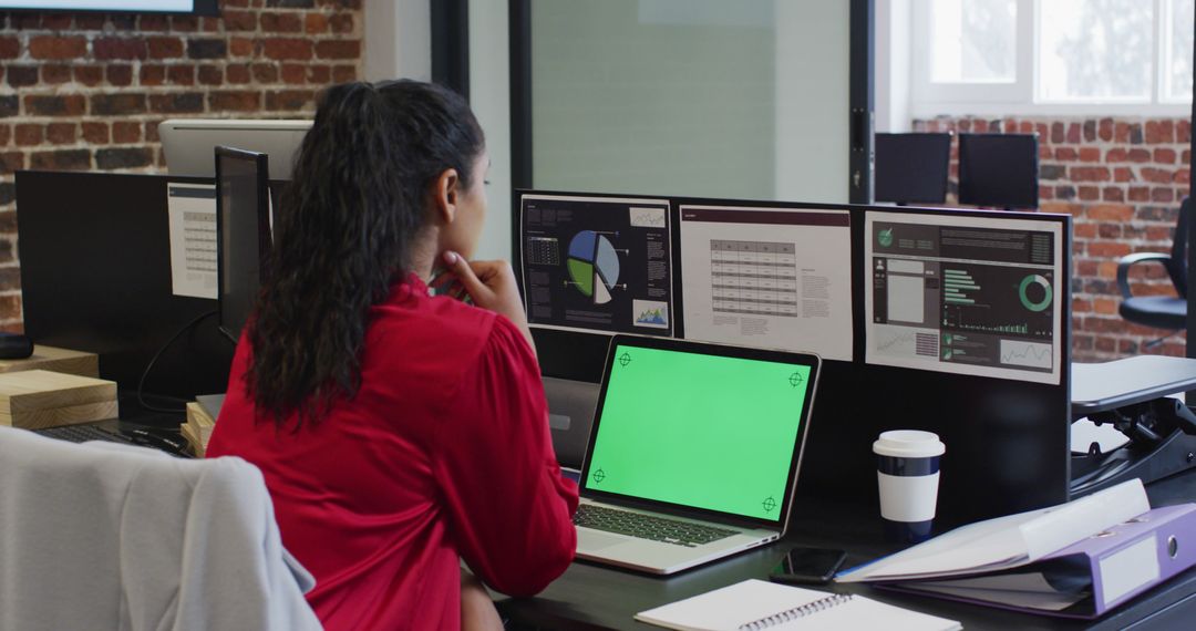 Woman Analyzing Data on Multiple Monitors in Office - Free Images, Stock Photos and Pictures on Pikwizard.com