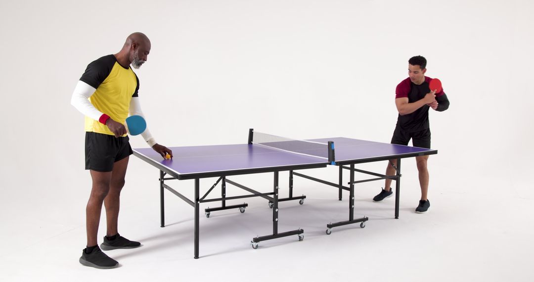 Diverse Men Preparing for Table Tennis Match in Modern Studio