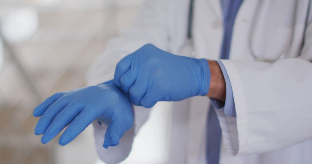 Medical Professional Putting On Blue Gloves for Examination - Free Images, Stock Photos and Pictures on Pikwizard.com