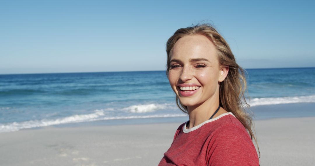 Smiling Woman Enjoying a Day on the Beach - Free Images, Stock Photos and Pictures on Pikwizard.com