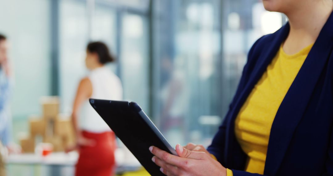 Casual Businesswoman Using Tablet in Modern Office Environment