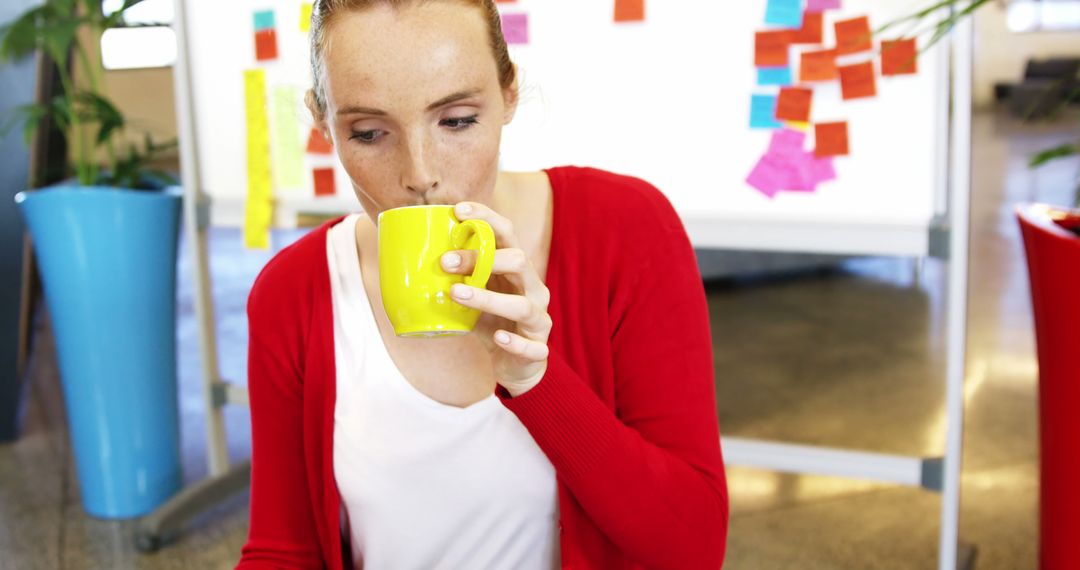 Businesswoman Enjoying Coffee in Creative Workspace with Sticky Notes - Free Images, Stock Photos and Pictures on Pikwizard.com