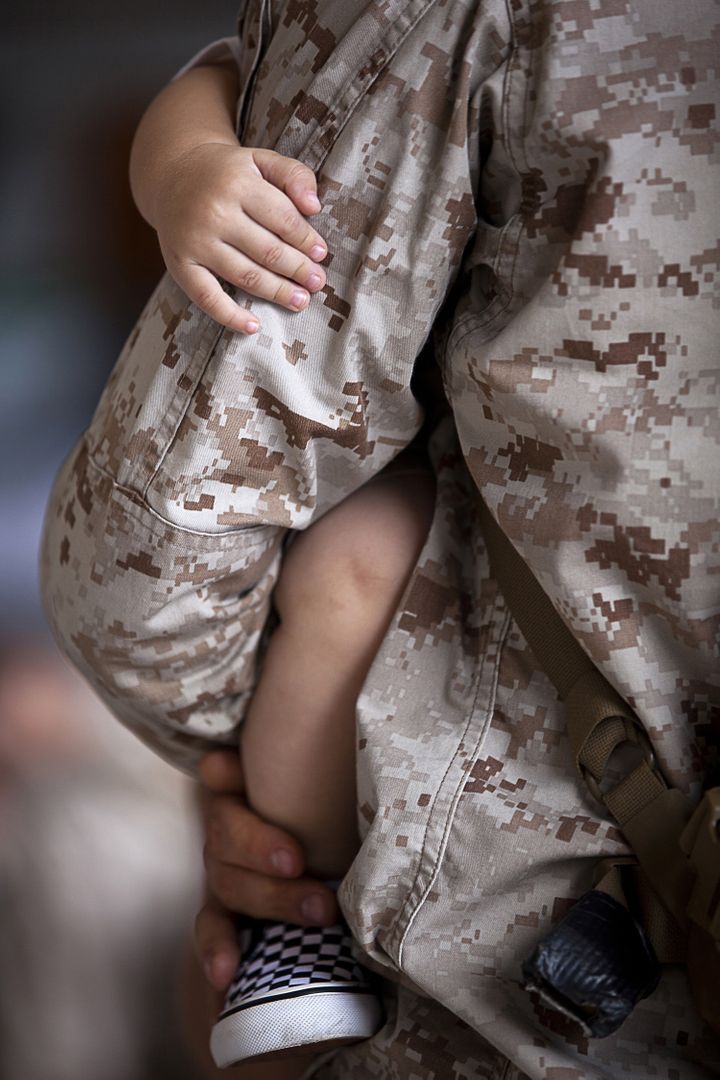 Military Parent Holding Child in Uniform - Free Images, Stock Photos and Pictures on Pikwizard.com