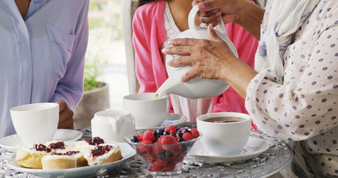 A diverse group enjoys an afternoon tea together, with copy space - Free Images, Stock Photos and Pictures on Pikwizard.com