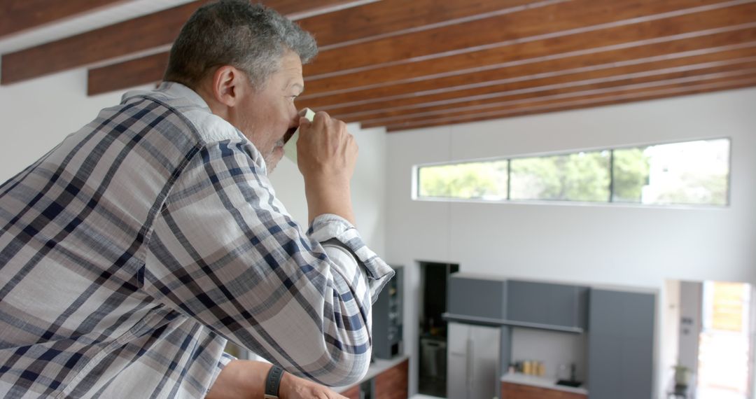 Thoughtful Man Drinking Coffee in Modern Home - Free Images, Stock Photos and Pictures on Pikwizard.com