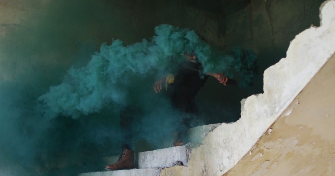 Person Moving Through Staircase with Colorful Smoke in Abandoned Building - Free Images, Stock Photos and Pictures on Pikwizard.com