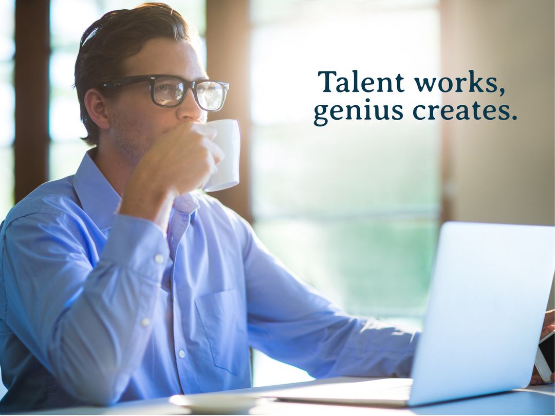 Focused Businessman Drinking Coffee While Working on Laptop