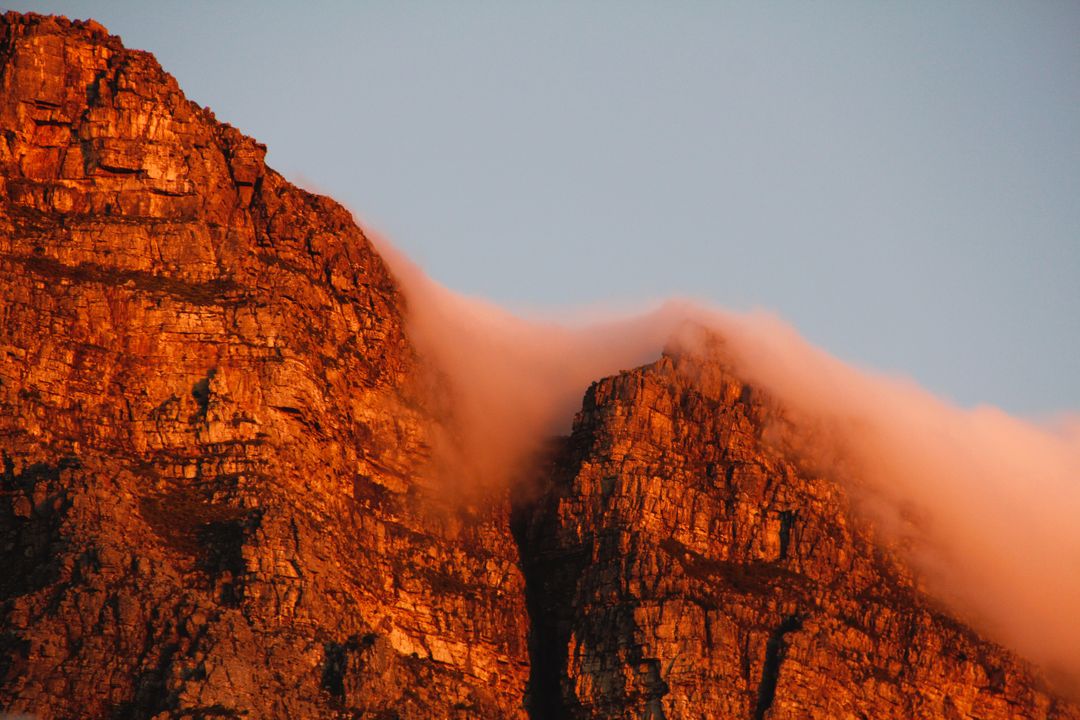 Sunlit Rocky Mountain Peaks with Mist at Sunset - Free Images, Stock Photos and Pictures on Pikwizard.com