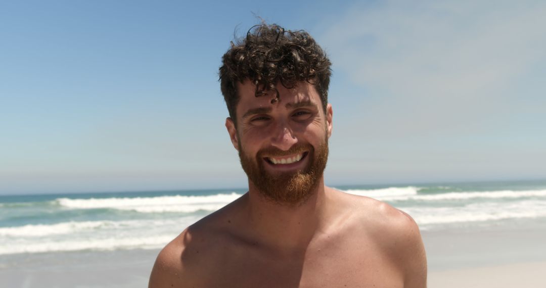 Smiling Shirtless Man Enjoying Sunny Beach Day - Free Images, Stock Photos and Pictures on Pikwizard.com