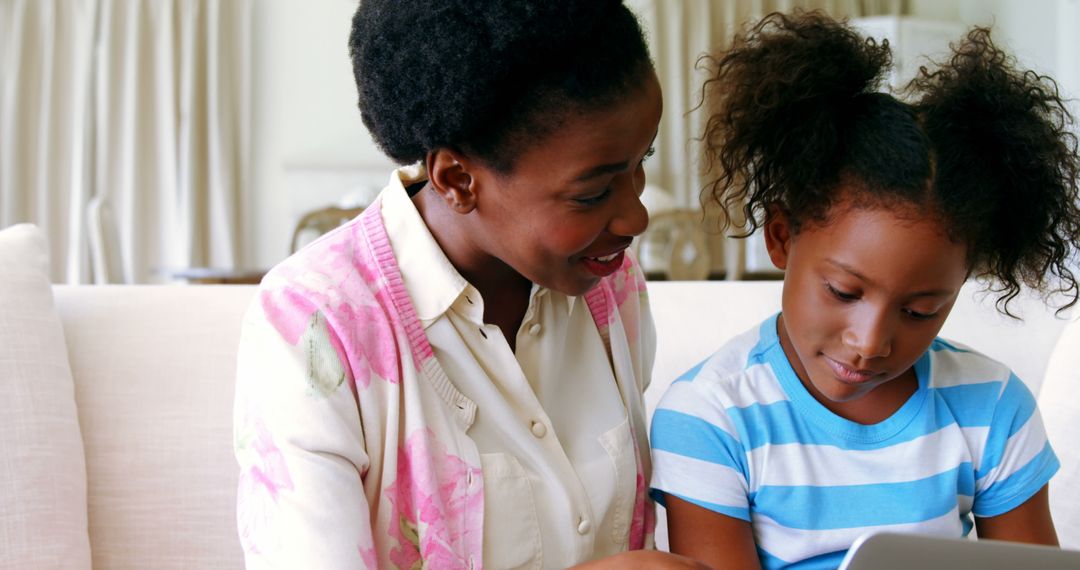 African American Woman Teaching Young Girl Using Tablet with Copy Space - Free Images, Stock Photos and Pictures on Pikwizard.com