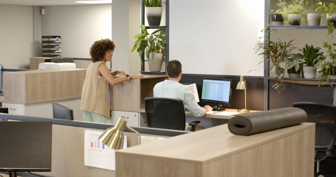 Coworkers Collaborating in Modern Office with Green Decor