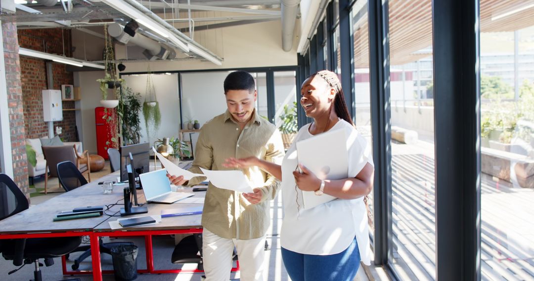 Diverse Colleagues Walking Cheerfully in Bright Modern Office