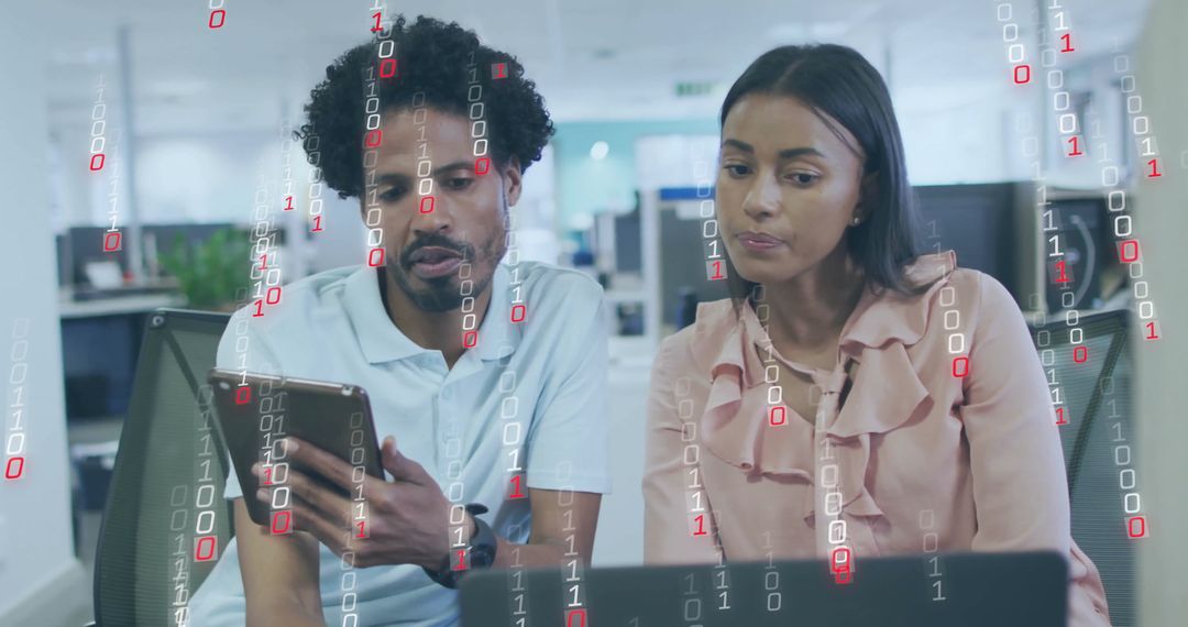 Diverse Colleagues Analyzing Data on Tablet and Laptop in Office Setting