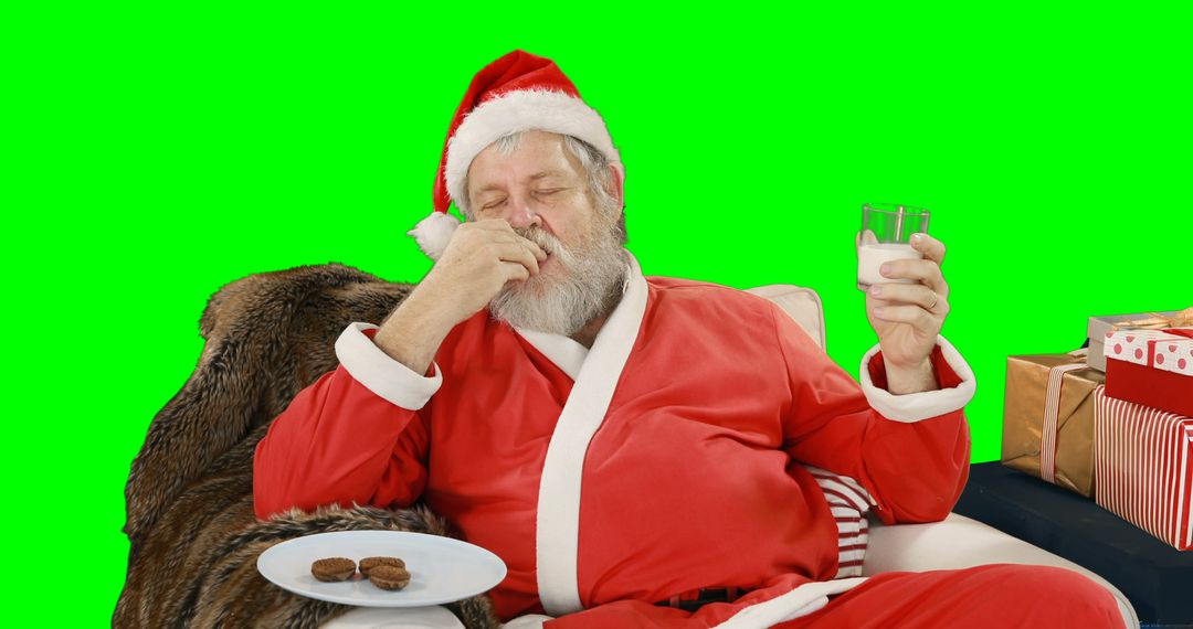 Santa Claus Eating Cookies and Drinking Milk on Sofa - Free Images, Stock Photos and Pictures on Pikwizard.com