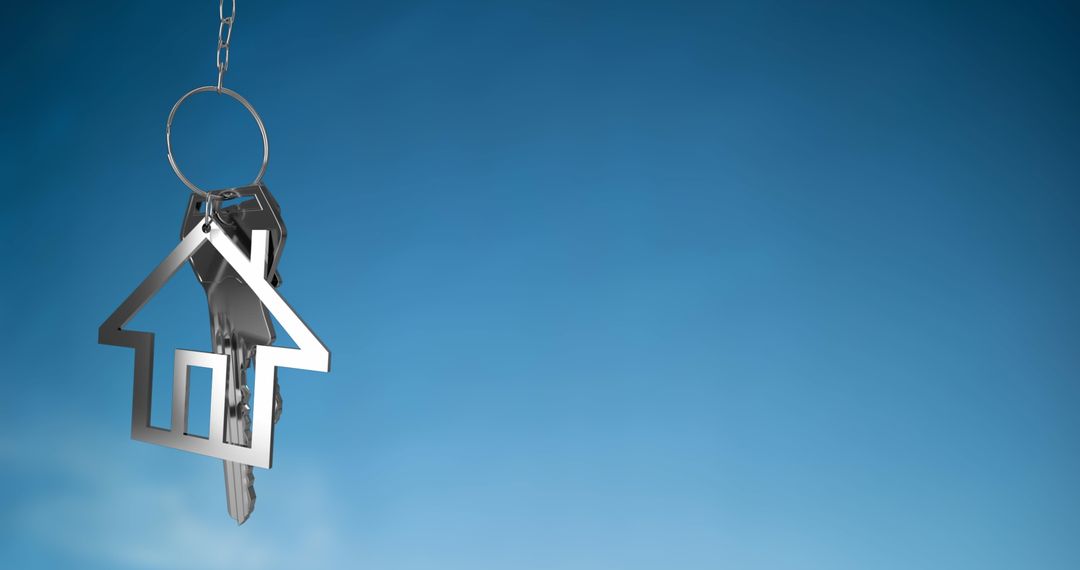 Silver House Key on Blue Background Symbolizing Real Estate