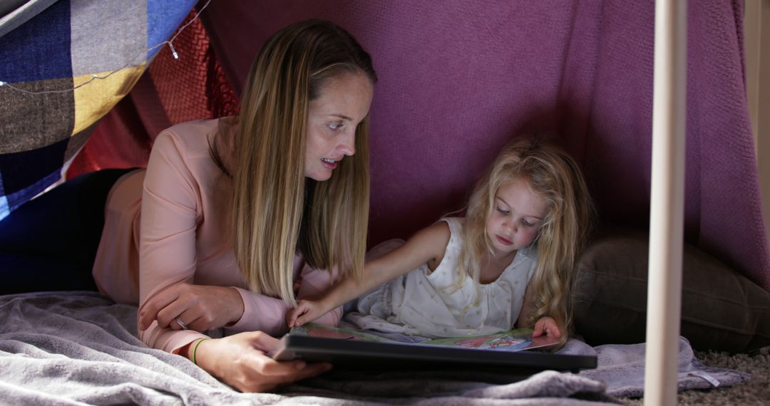 Mother Reading Storybook to Young Daughter in Blanket Fort - Free Images, Stock Photos and Pictures on Pikwizard.com