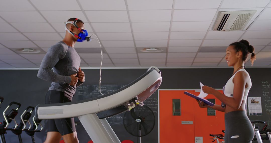 Athlete under physical test running on treadmill with trainer writing results - Free Images, Stock Photos and Pictures on Pikwizard.com