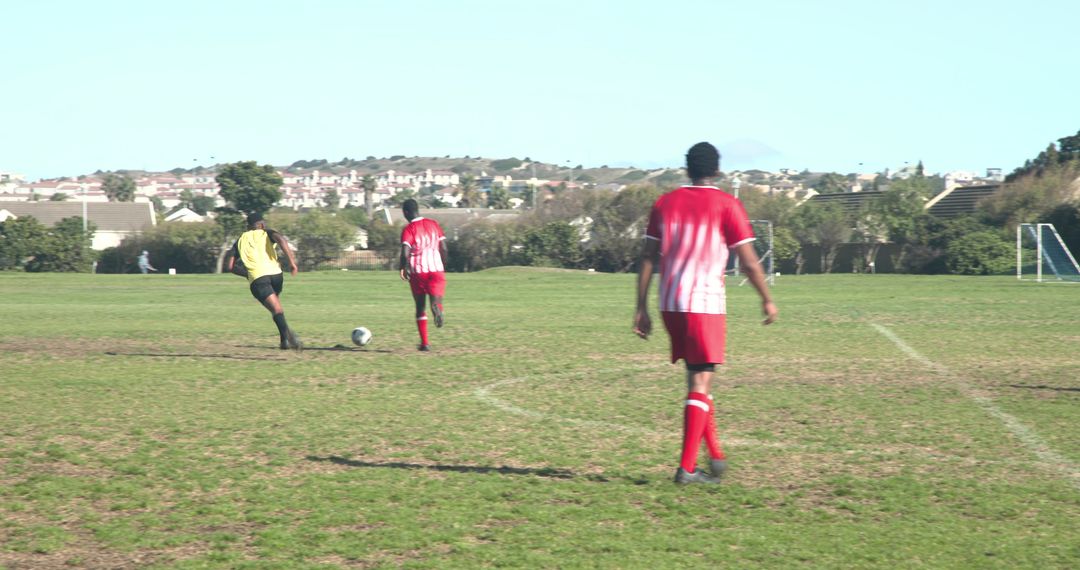 Soccer Players in Action on Sunny Day