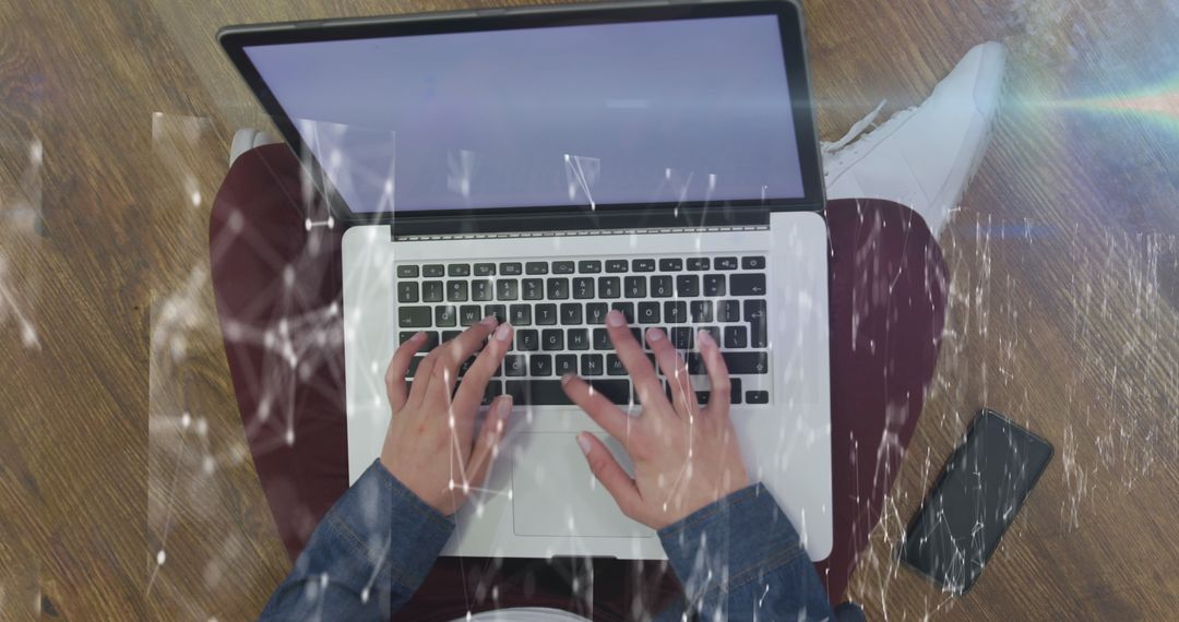 Person Typing on Laptop with Network Connection Overlay
