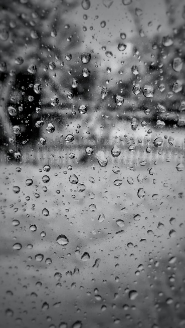 Raindrops Streaking Down Glass with Blurred Background in Black and White - Free Images, Stock Photos and Pictures on Pikwizard.com