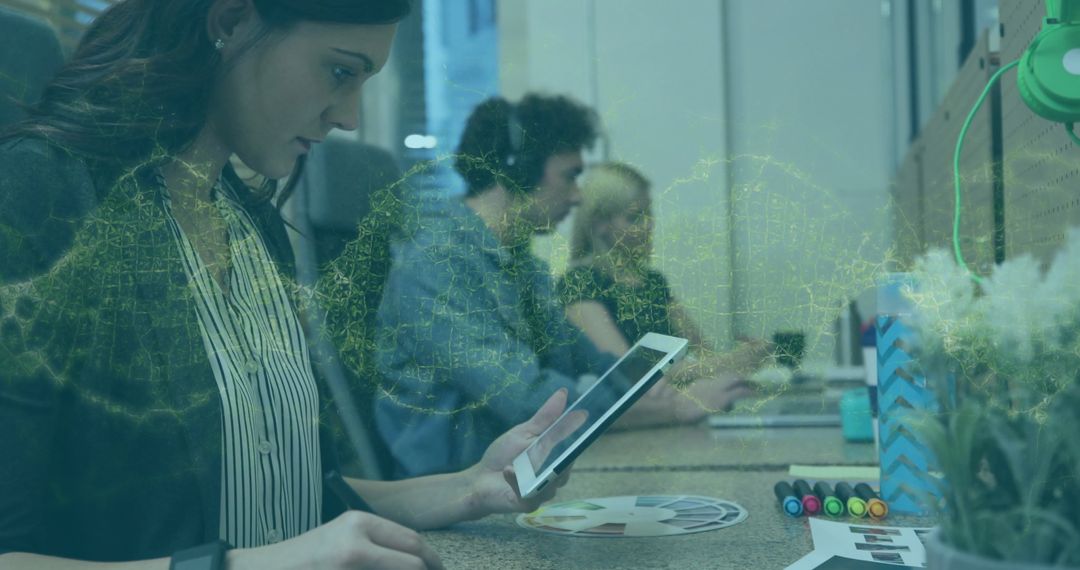 Graphic Designer Using Tablet in Modern Collaborative Workspace