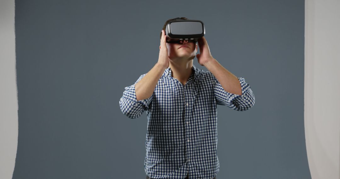 Man Experiencing Virtual Reality with VR Headset in Studio - Free Images, Stock Photos and Pictures on Pikwizard.com