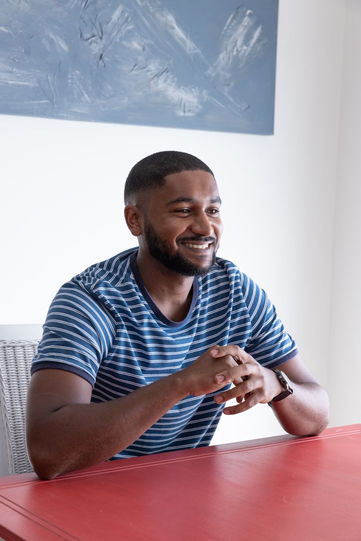 Smiling African American Man Relaxing at Modern Home