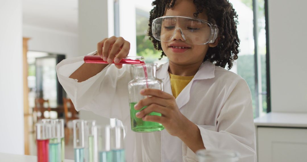 Young Scientist in Classroom Experimenting with Beakers
