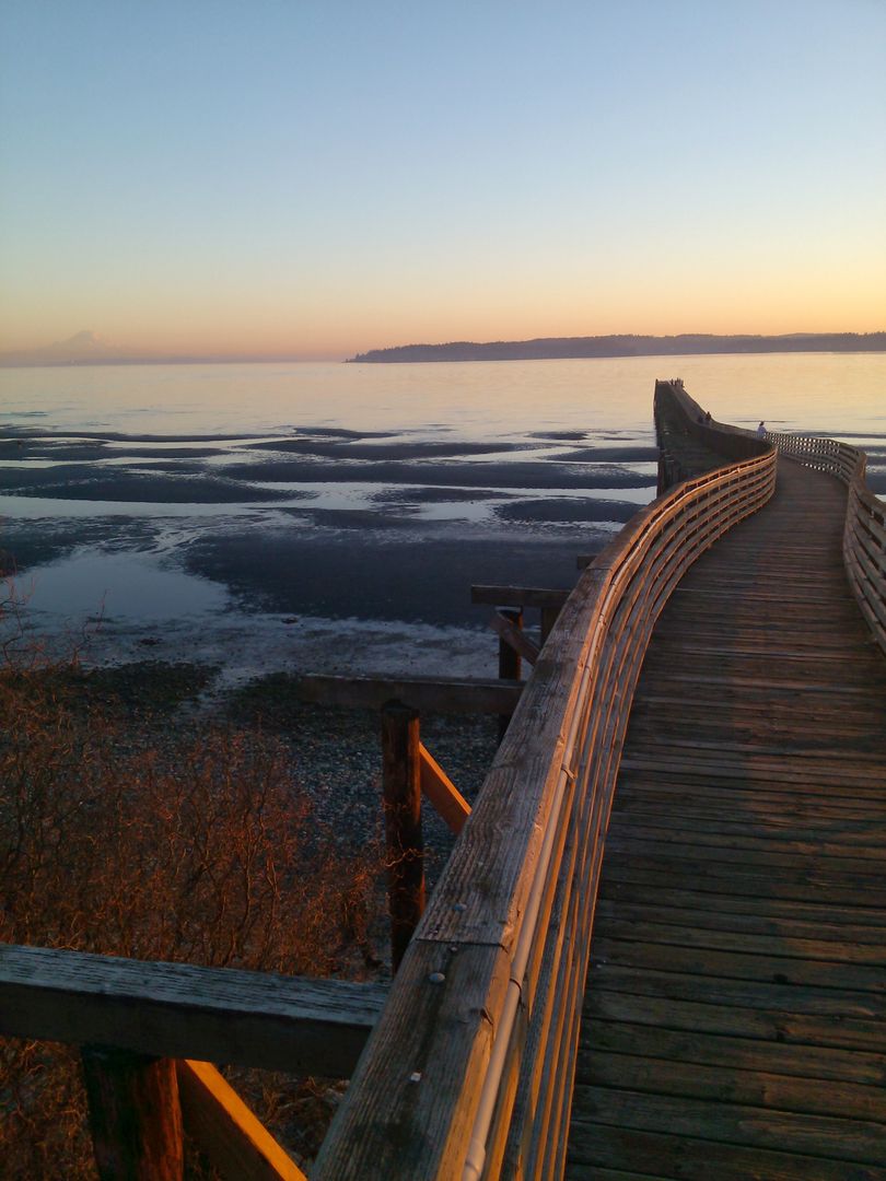 Boardwalk Curving into Scenic Beach During Golden Sunset - Free Images, Stock Photos and Pictures on Pikwizard.com