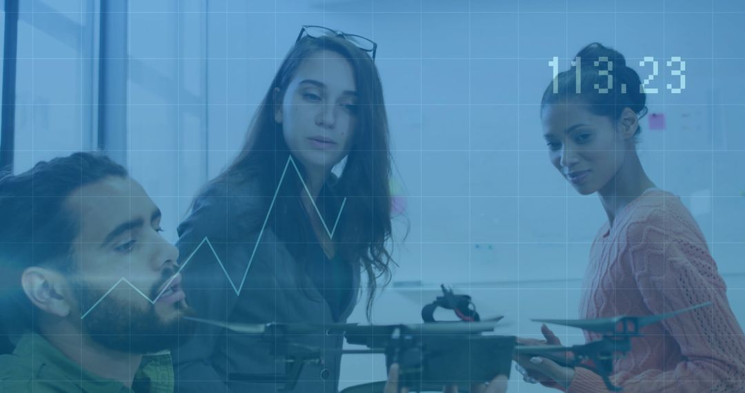 Diverse Professionals Analyzing Technology with Financial Data Overlay