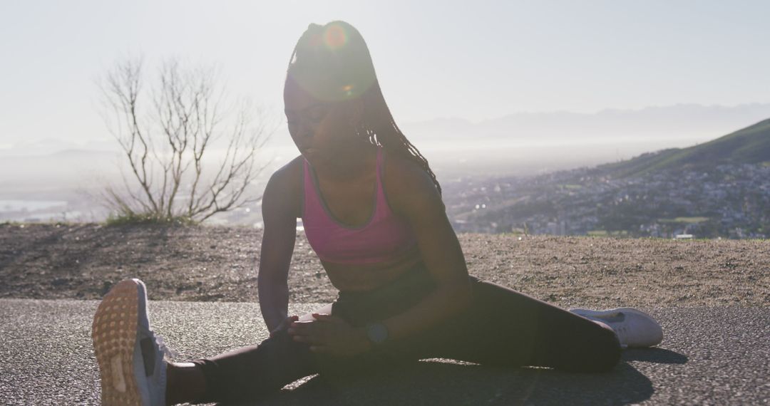 Female Athlete Stretching Outdoors at Sunrise - Free Images, Stock Photos and Pictures on Pikwizard.com