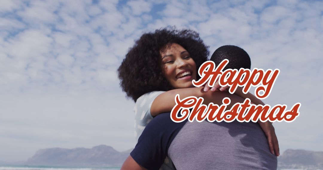 Diverse Couple Embracing on Beach with Christmas Greeting