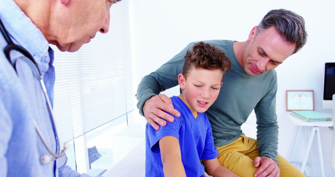 Father and Doctor Consoling a Child with an Injury in Clinic - Free Images, Stock Photos and Pictures on Pikwizard.com