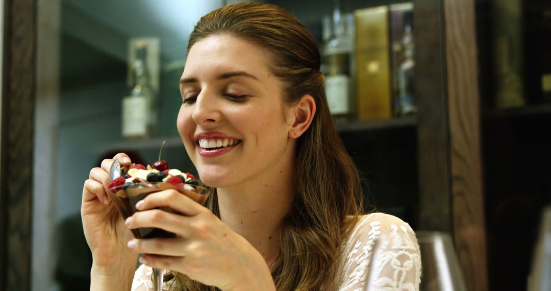 Smiling Woman Enjoying Delicious Dessert at Restaurant - Free Images, Stock Photos and Pictures on Pikwizard.com