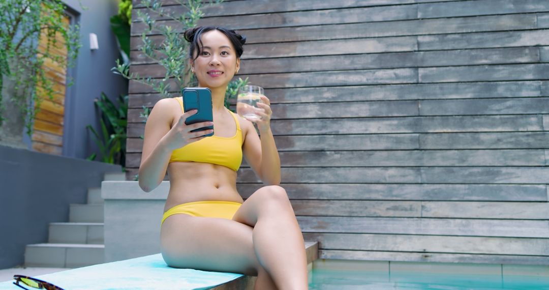Woman Enjoying Poolside Relaxation in Yellow Swimsuit