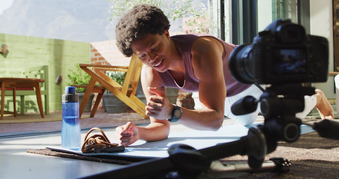 Man Filming Home Fitness Vlog While Exercising on Mat