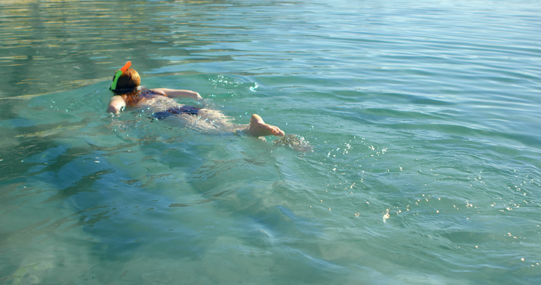 Person enjoys a serene swim in clear blue waters, with copy space - Free Images, Stock Photos and Pictures on Pikwizard.com