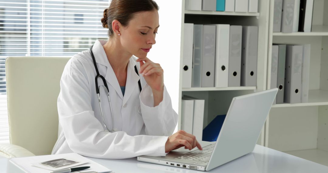 Female Doctor Using Laptop in Medical Office - Free Images, Stock Photos and Pictures on Pikwizard.com