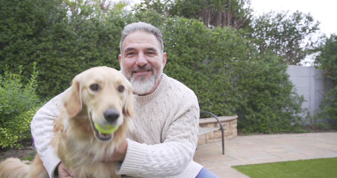 Senior Man Bonding with Playful Golden Retriever on Patio