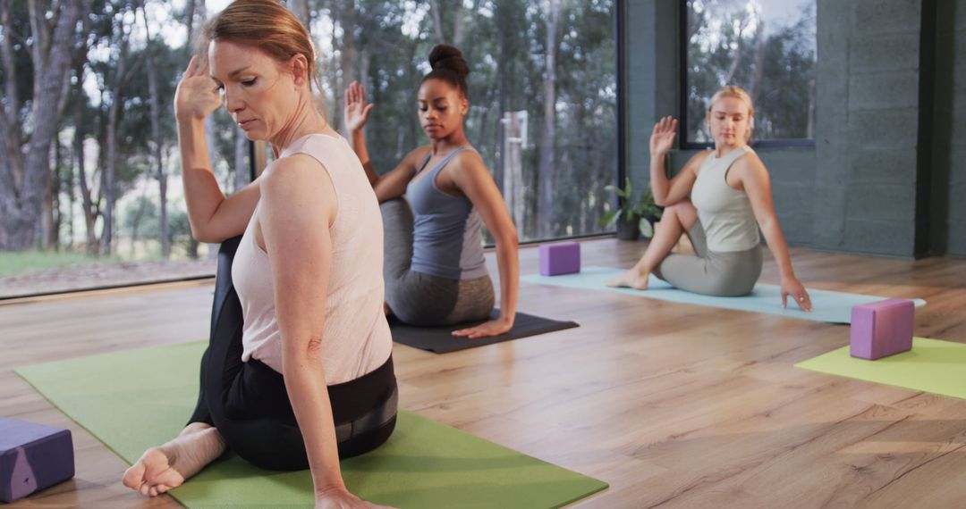 Diverse Women Engaging in Yoga Practice for Wellbeing - Free Images, Stock Photos and Pictures on Pikwizard.com