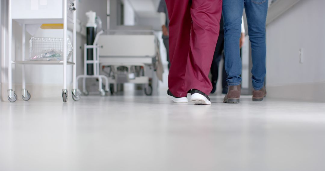 Medical Professionals Walking Down Hospital Hallway - Free Images, Stock Photos and Pictures on Pikwizard.com